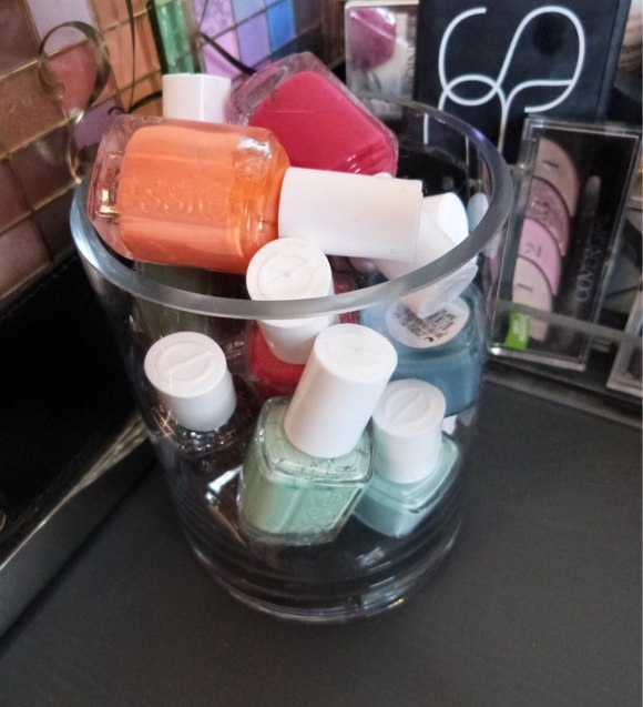 [Some of my favorite nail polishes shades on display in a re-purposed flower vase]